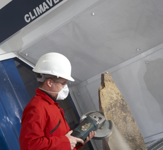 Stone cutting being undertaken on heavy duty down draught bench