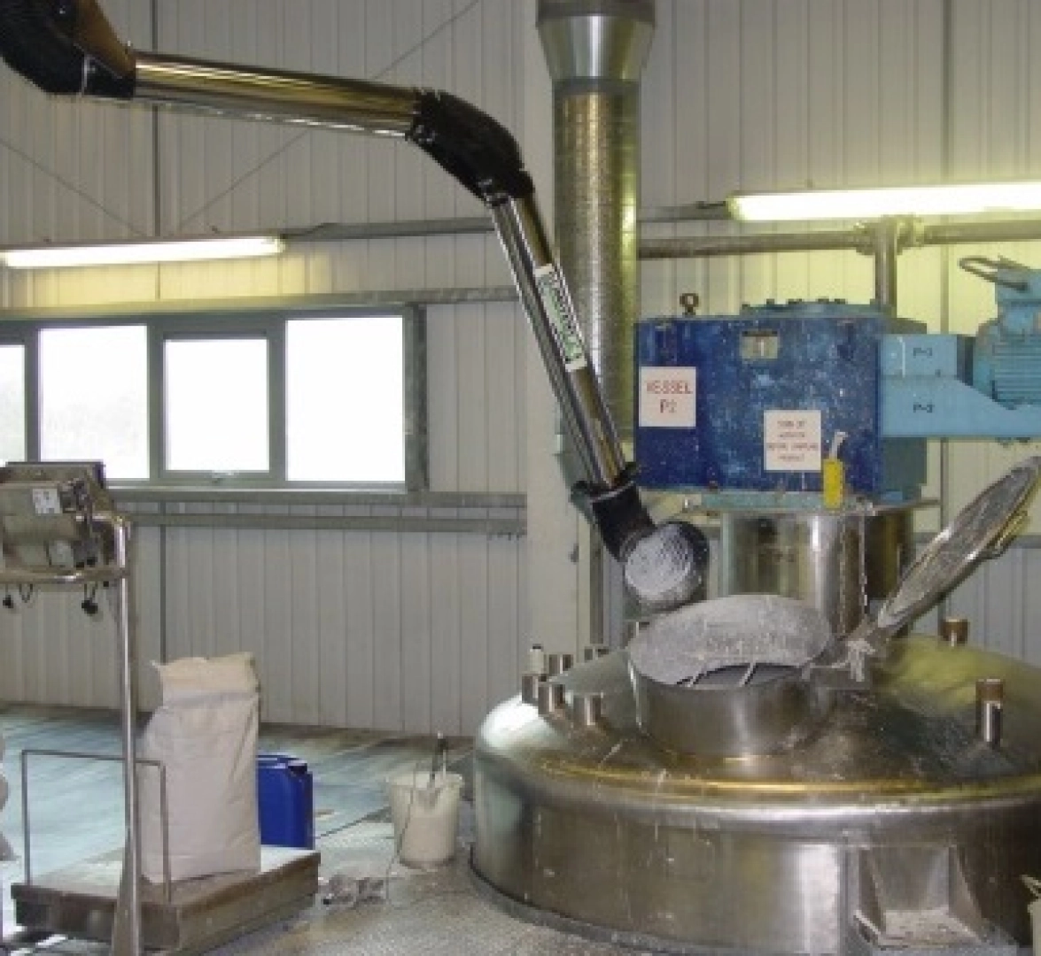 Dust extraction arm sited over a barrel to ensure the extraction of dust generated during sack tipping.