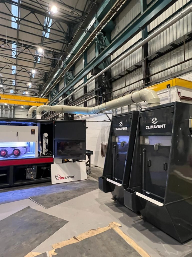 A bank of wet collector units connected onto a Timesaver machine for use during deburring.